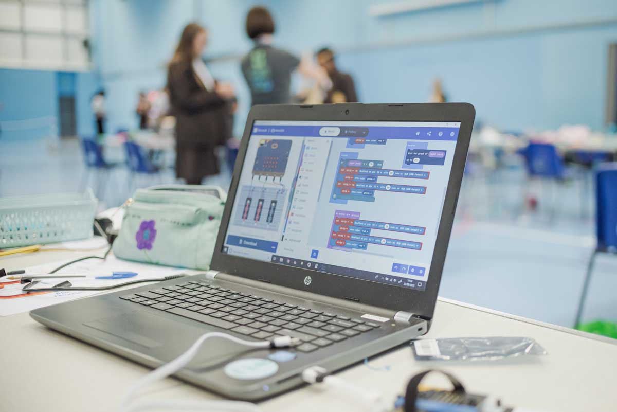 Photograph of a laptop computer in a school computing workshop.