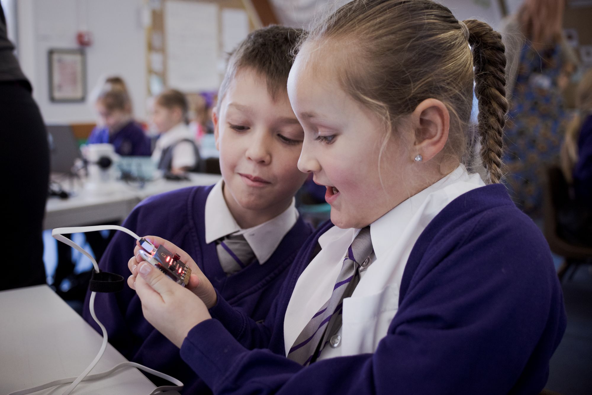 A boy and girl at school in a computing workshop.