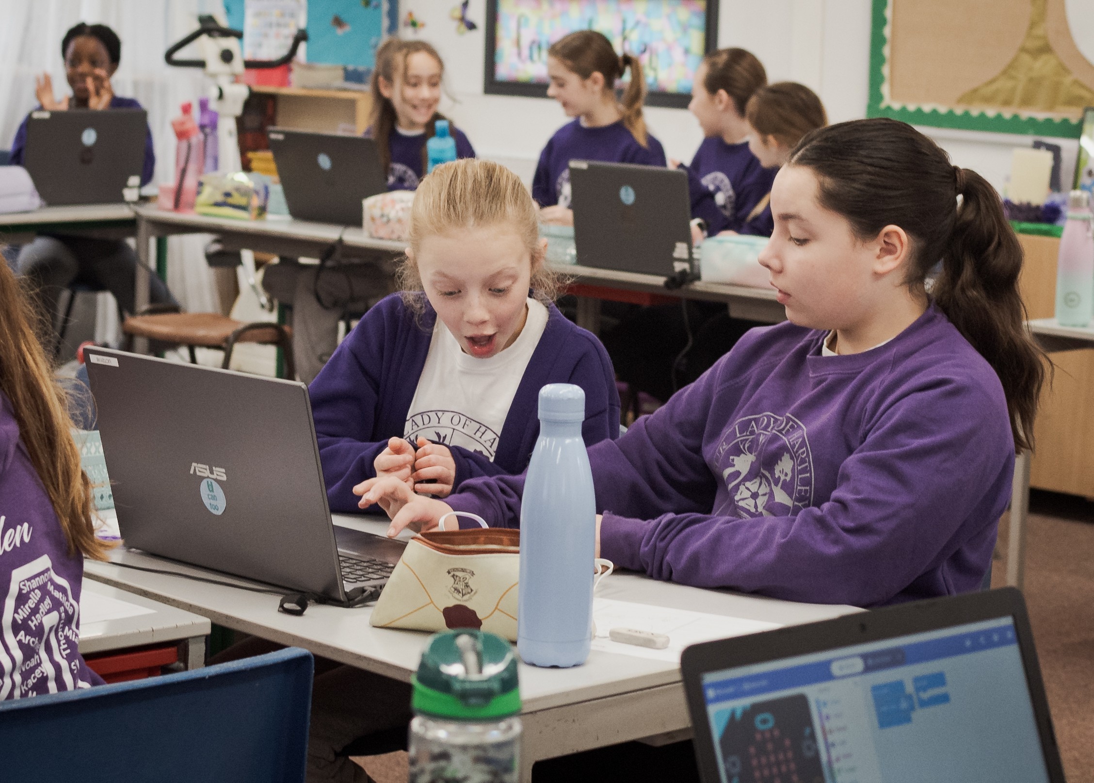 A boy and girl at school in a computing workshop.